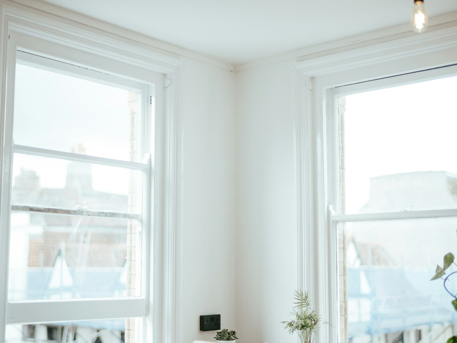 A bright coworking space with desks and large windows over the sea