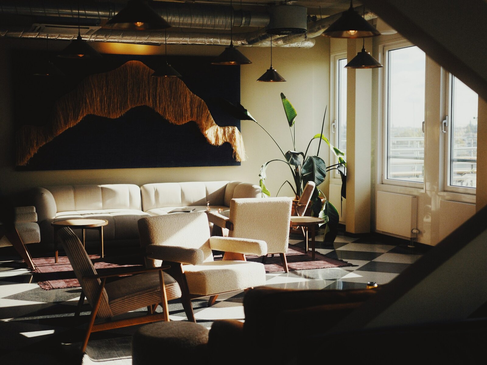 A comfortable coworking lounge with sofas and plants
